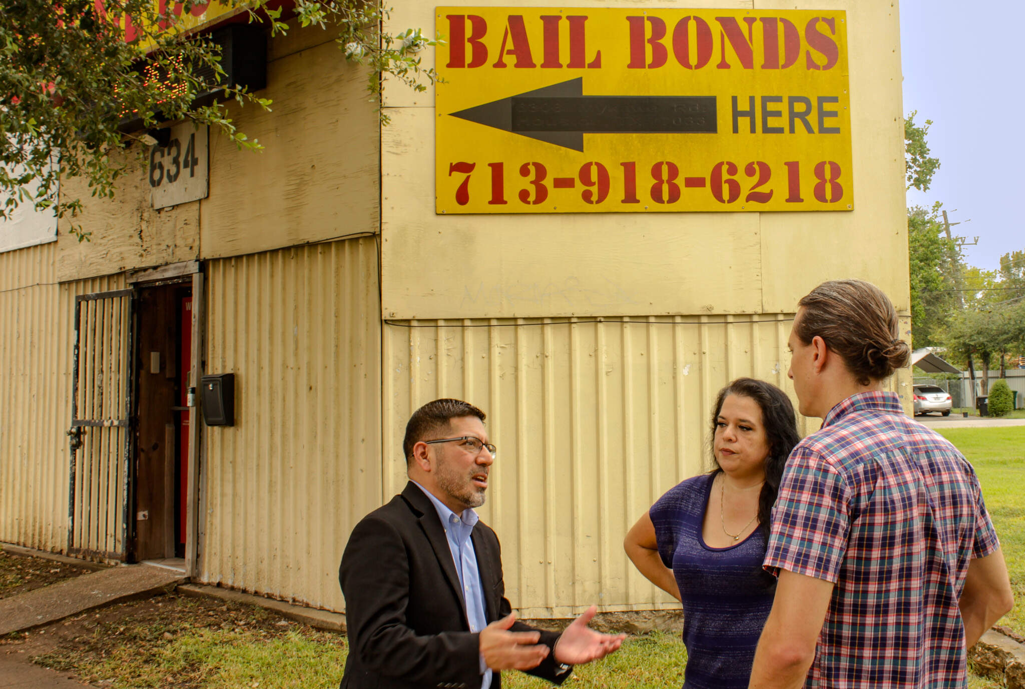 Mario Garza, Michelle Chappa and Peter O'Dowd face 1st Advantage Bail Bonds in Houston, Texas. (Wilder Fleming/Here & Now)