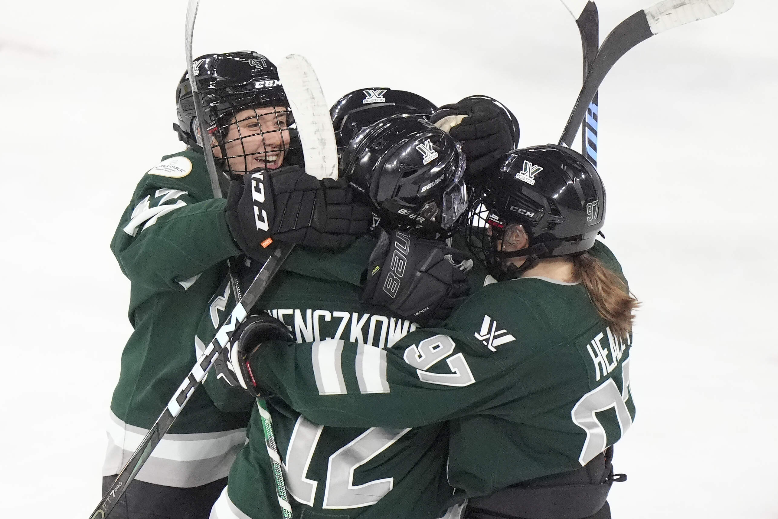 Teammates celebrate after Boston scored during a PWHL hockey championship series in Lowell, Mass. (Steven Senne/AP)
