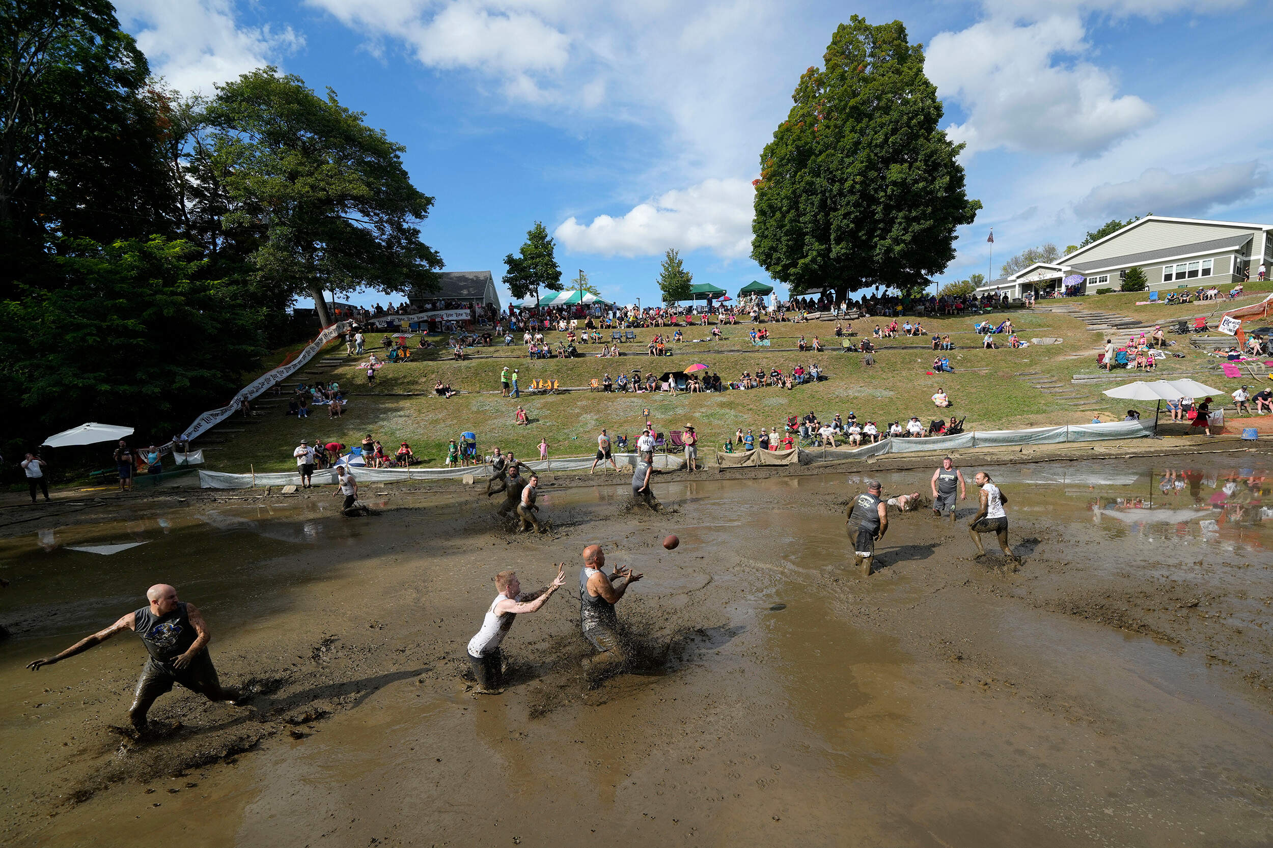 The Muckaneers take on the Muddas' at the 2024 Mud Bowl football game at Hog Coliseum. (Robert F. Bukaty/AP)