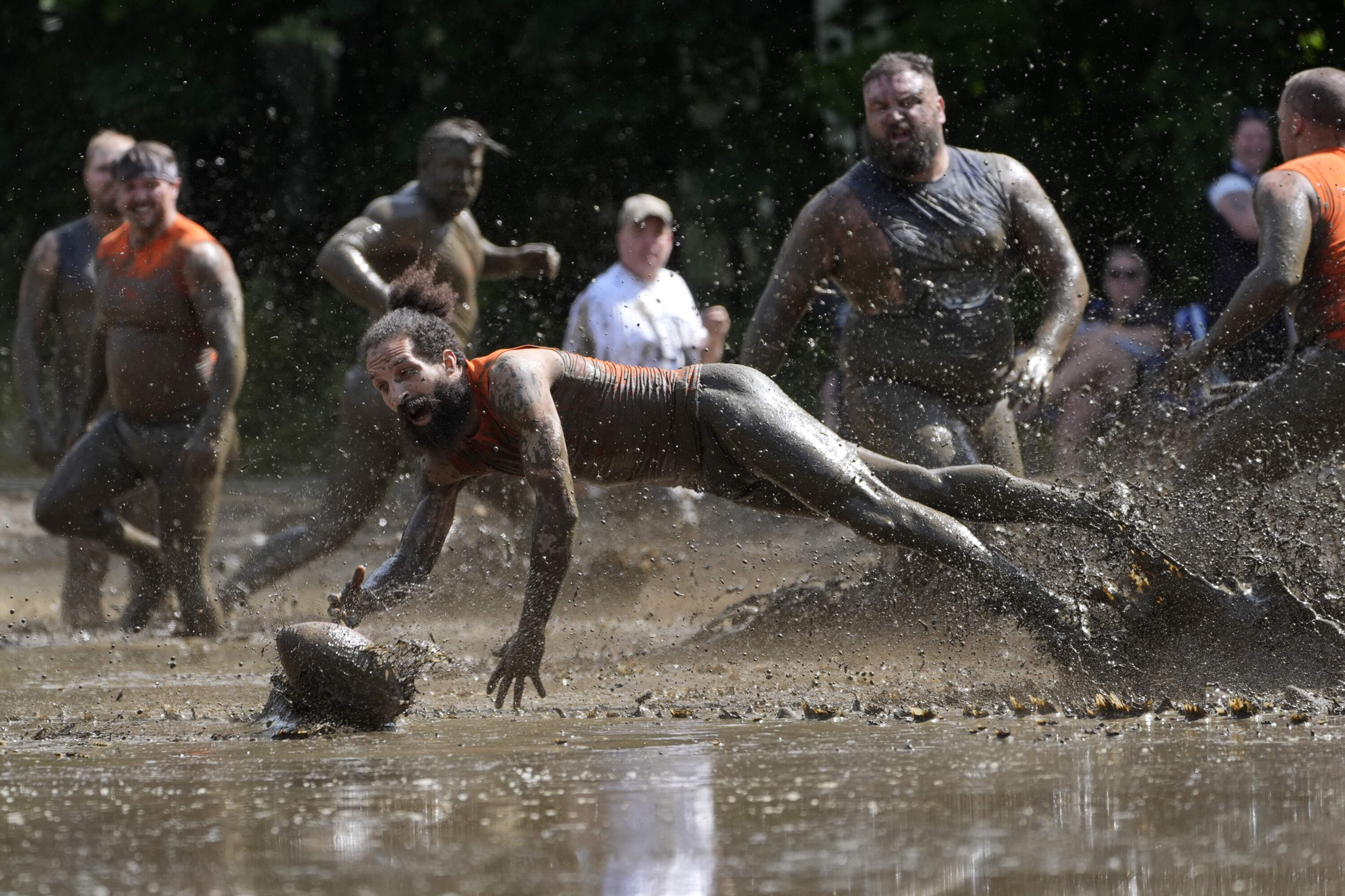 Andre Rioux, of Nashua, N.H., dives for the ball in a football game at the Mud Bowl. (Robert F. Bukaty/AP)
