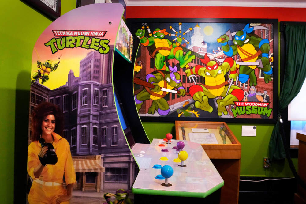 A Teenage Mutant Ninja Turtle arcade video game and painting by a local artist are displayed as part of the permanent collection at the Woodman Museum. (Charles Krupa/AP)