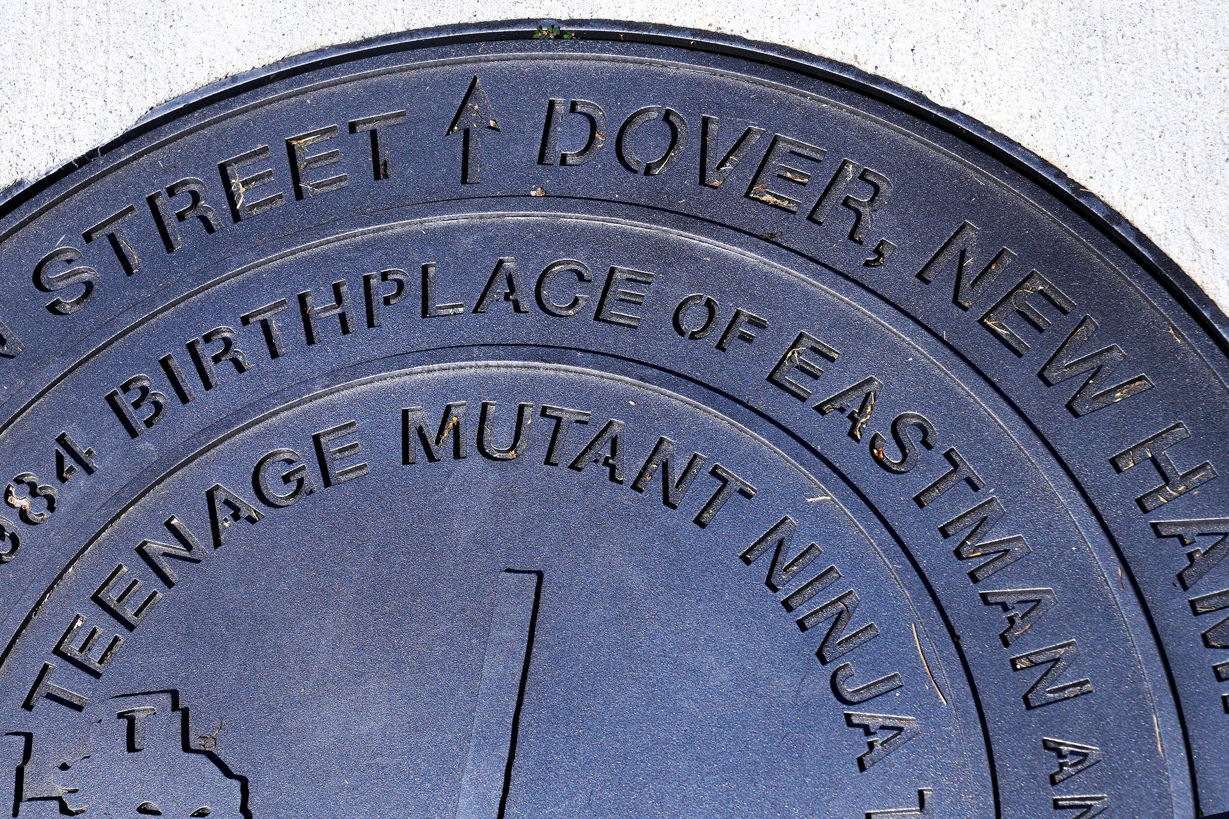 A city manhole cover, noting the Dover, New Hampshire birthplace of the Teenage Mutant Ninja Turtles, is seen at the outside the property in Dover. (Charles Krupa/AP)