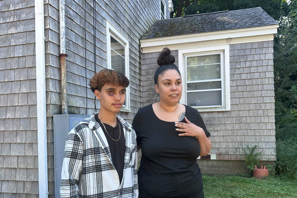 Jayden Tkaczyk stands outside his house with his mother, Jasmine Tkaczyk. (Michael Casey/AP)