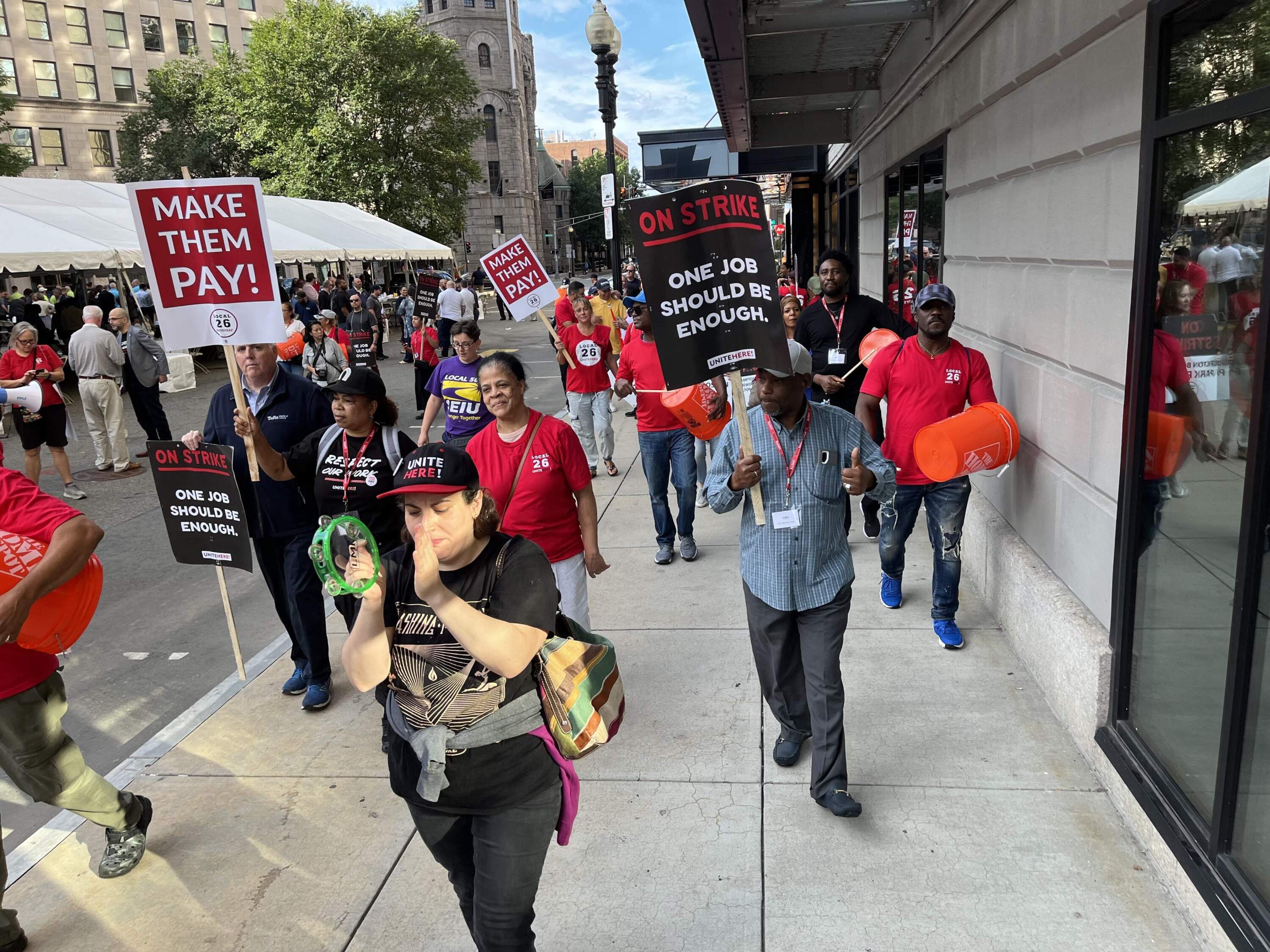 Hundreds of union hotel workers on strike marched and chanted "Make them pay!" Monday in Boston. (Barbara Moran/WBUR)