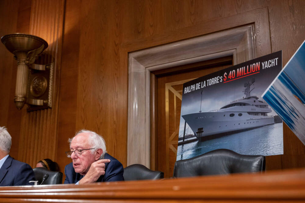 Sen. Bernie Sanders points to a photo of a yacht owned by Steward Health Care System CEO Ralph de la Torre who failed to testify before the Senate Health, Education, Labor, and Pensions hearing to examine the bankruptcy of Steward Health Care last week. (Kevin Wolf/AP)