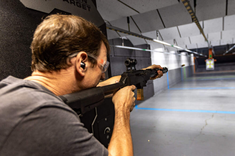 A bullet shell flies from an Ruger PC Carbine Semi-Automatic Rifle Toby Leary is demonstrating at the firing range at Cape Gun Works of guns that will be banned once the gun reform law goes into effect. (Jesse Costa/WBUR)