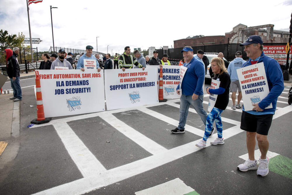 Striking dockworkers from the International Longshoremen’s Association block the entrance to the Conley Container Terminal in Boston. (Robin Lubbock/WBUR)