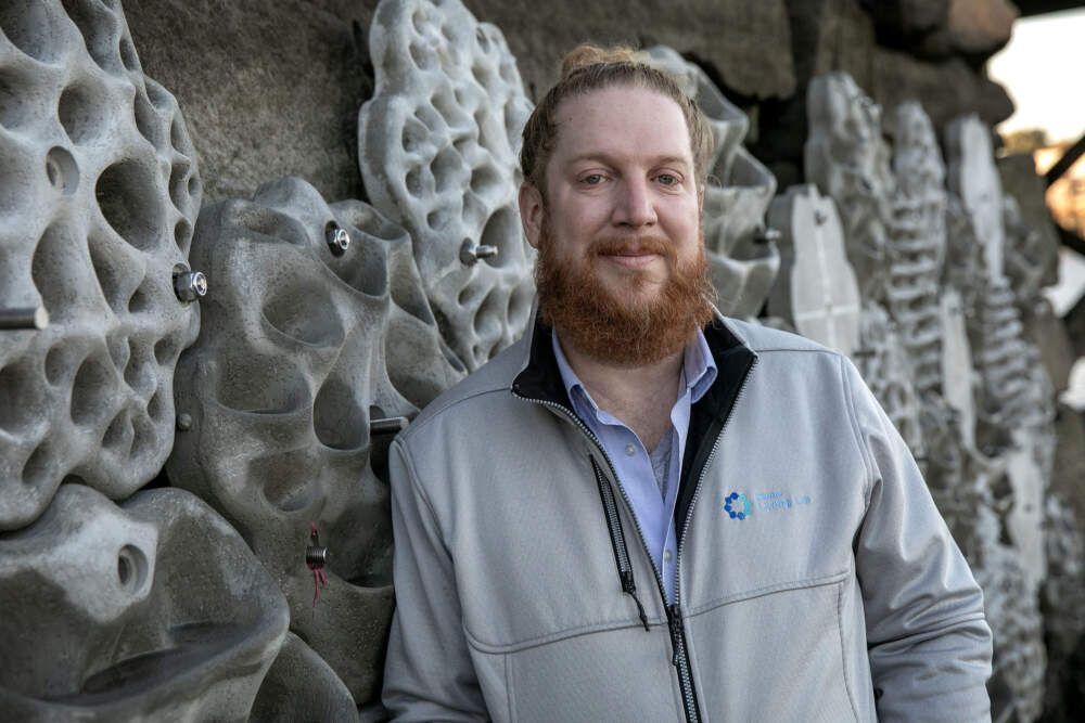 Joe Christo, Boston Harbor Now's chief sustainability officer, near the new Condor Street Urban Wild living wall in East Boston. (Robin Lubbock/WBUR)