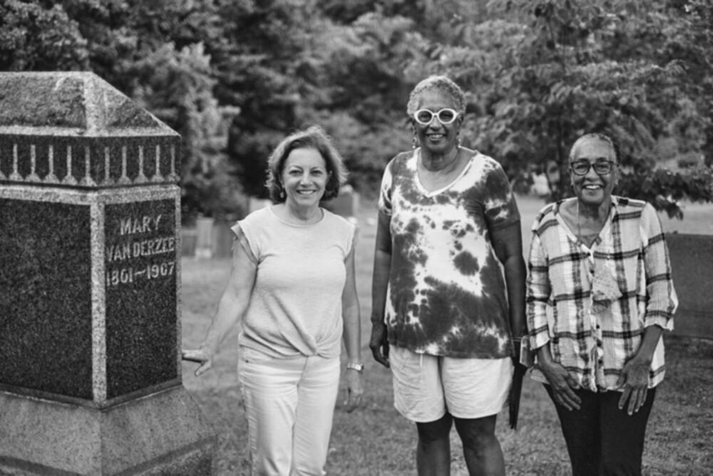 Debra Bruno, Eleanor Mire, and Beverly Mire stand at the gravesite of matriarch Mary Vanderzee at Riverside Cemetery in Coxsackie. (Courtesy of Jonathan Palmer)