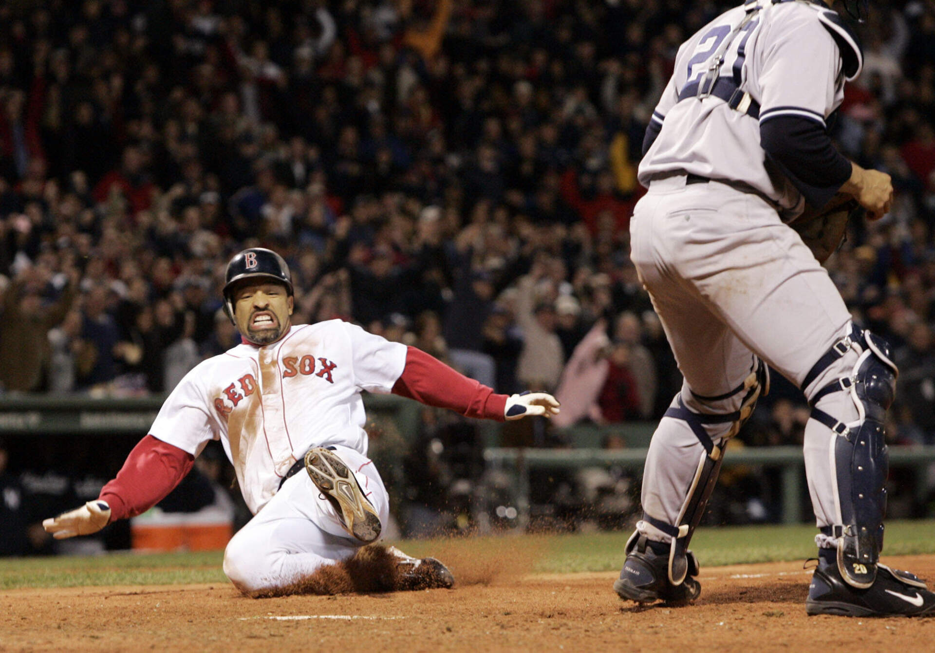 Boston Red Sox's Dave Roberts slides home to score the tying run against New York Yankees pitcher Mariano Rivera in the ninth inning of game 4 of the ALCS Sunday, Oct. 17, 2004 in Boston. (Elise Amendola/AP)