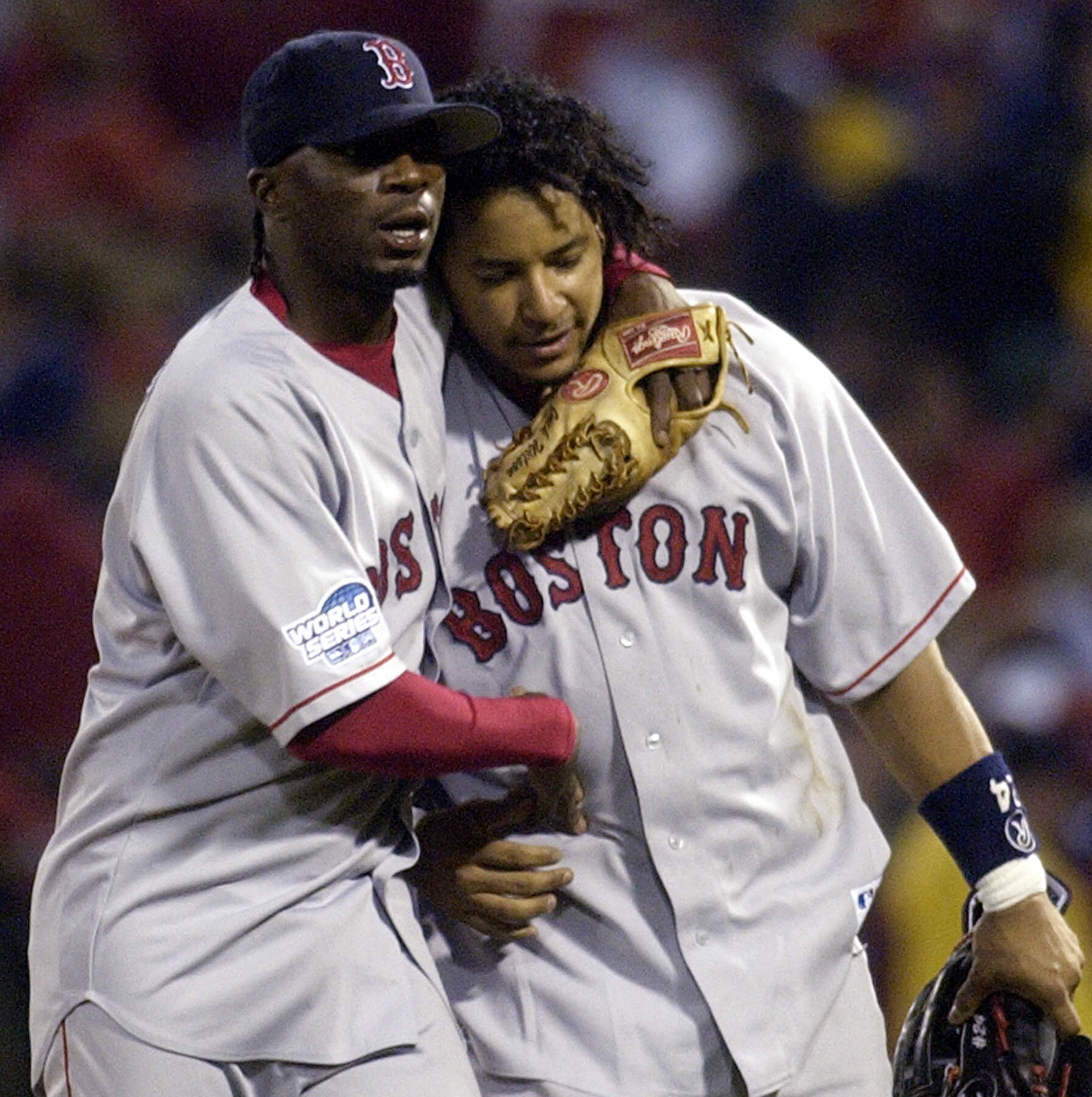 Boston Red Sox' Pokey Reese, left, hugs Manny Ramirez after the Red Sox beat the St. Louis Cardinals 4-1 in Game 3 of the World Series Tuesday, Oct. 26, 2004, in St. Louis. (Charles Rex Arbogast/AP)