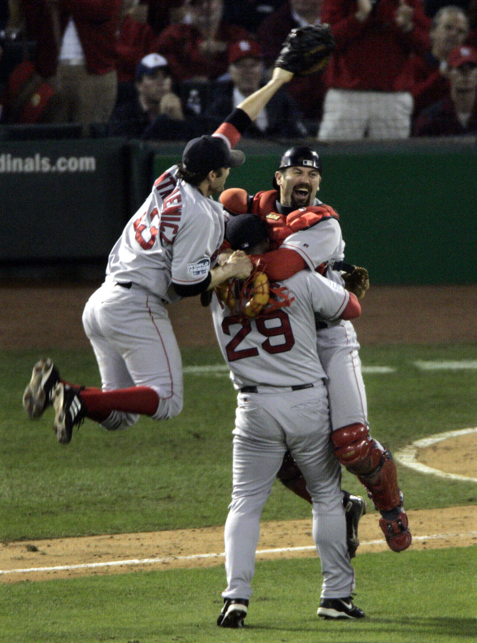 Boston Red Sox's Doug Mientkiewicz, left and catcher Jason Varitek jump into Keith Foulke's (29) arms after the Red Sox defeated the St. Louis Caridnals 3-0 in Game 4 to win the World Series at Busch Stadium in St. Louis, Wednesday, Oct. 27, 2004. (Sue Ogrocki/AP)