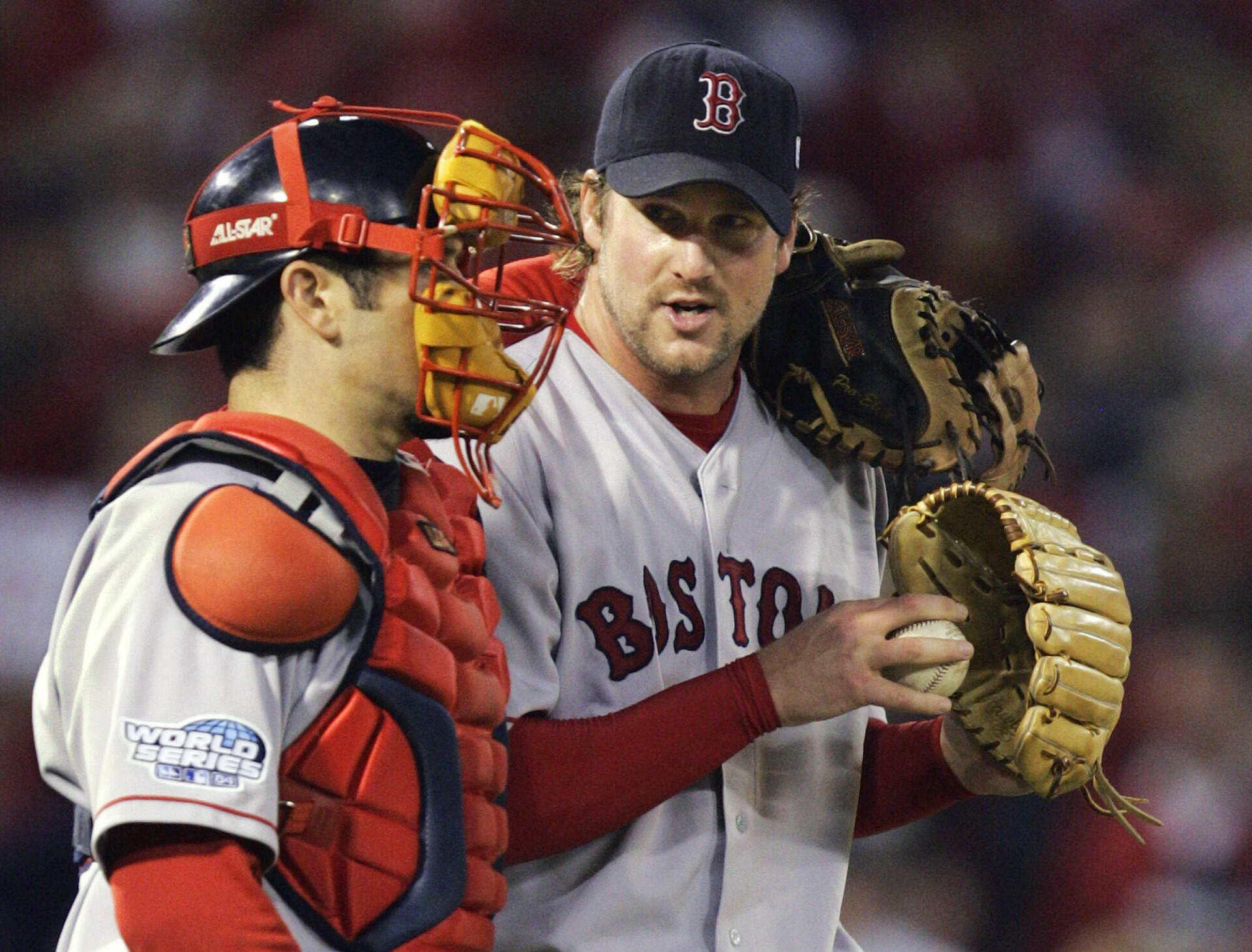 Boston Red Sox catcher Jason Varitek talks to pitcher Derek Lowe during the sixth inning of Game 4 of the World Series against the St. Louis Cardinals Wednesday, Oct. 27, 2004, in St. Louis. (Al Behrman/AP)