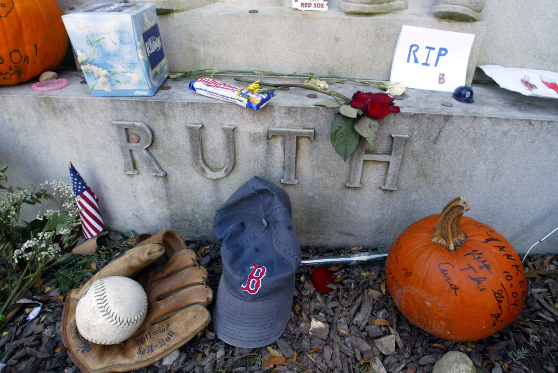 The grave of George Herman 'Babe'' Ruth is decorated with items left by New York Yankees and Boston Red Sox fans, Thursday, Oct. 28, 2004 in Hawthorne, New York.(Mary Altaffer/AP)