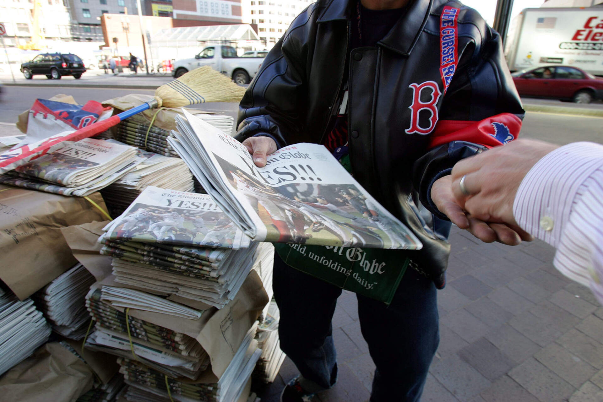 Adam Hutchinson of Boston sells newspaper, which reports Red Sox victory in the World Series on the front page, in front of the South Station in Boston, Thursday, Oct. 28, 2004. (Chitose Suzuki/AP)