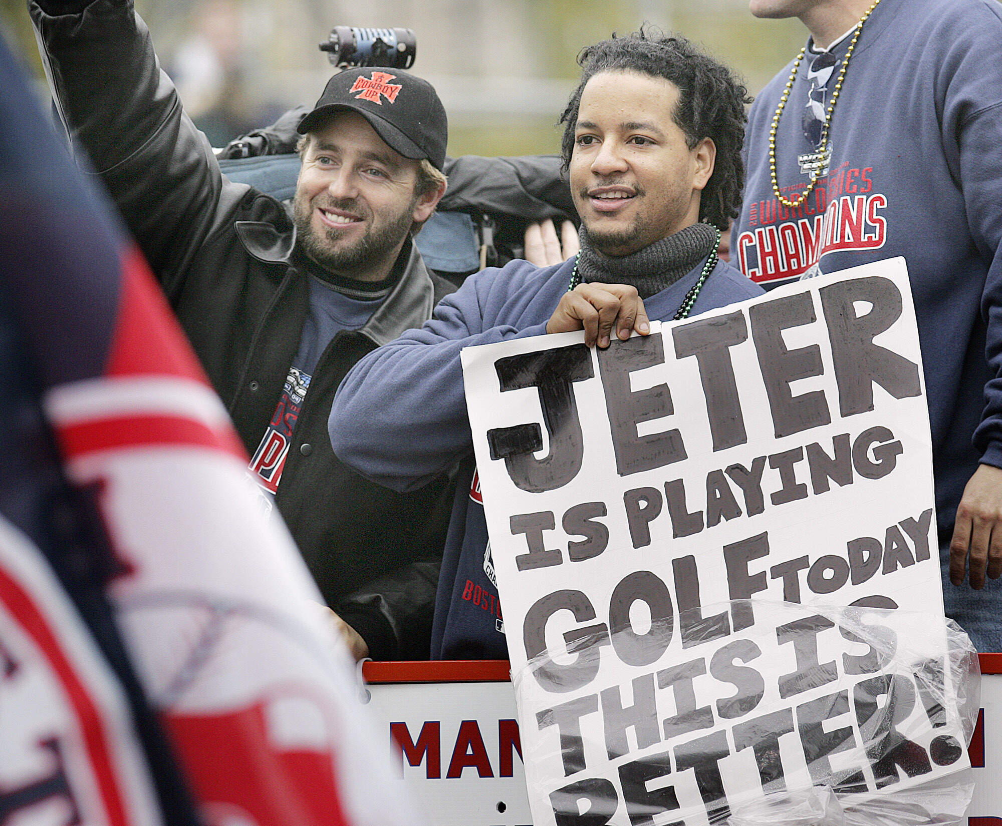 Boston Red Sox's Kevin Millar, left, and Manny Ramirez, right, react to the crowd during the Red Sox World Series Championship parade through the streets of Boston, Saturday, Oct. 30, 2004. (Michael Dwyer/AP)