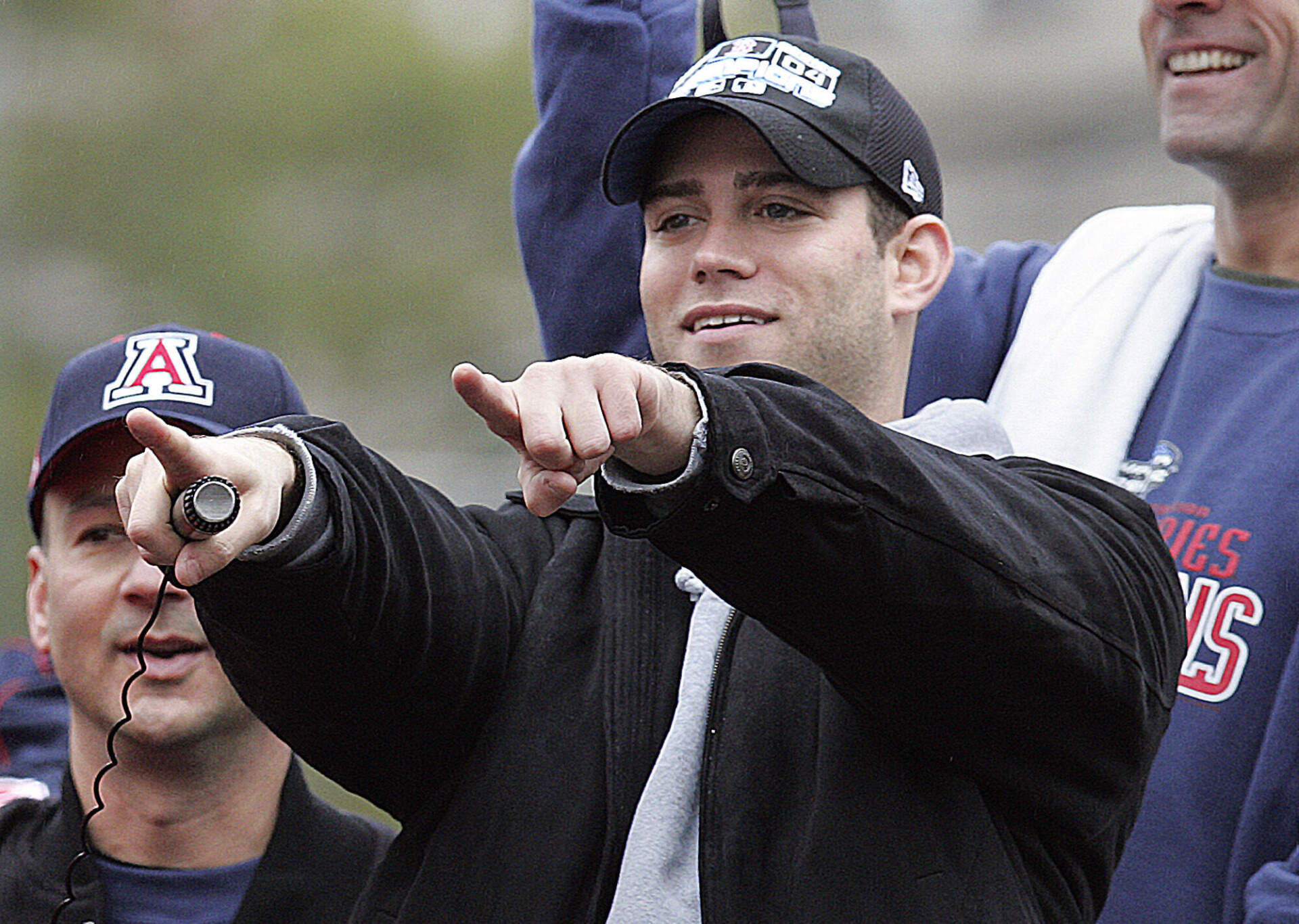 Boston Red Sox general manager Theo Epstein points to the crowd as manager Terry Francona, left, looks on during the Red Sox World Series Championship parade through the streets of Boston, Saturday, Oct. 30, 2004. (Michael Dwyer/AP)