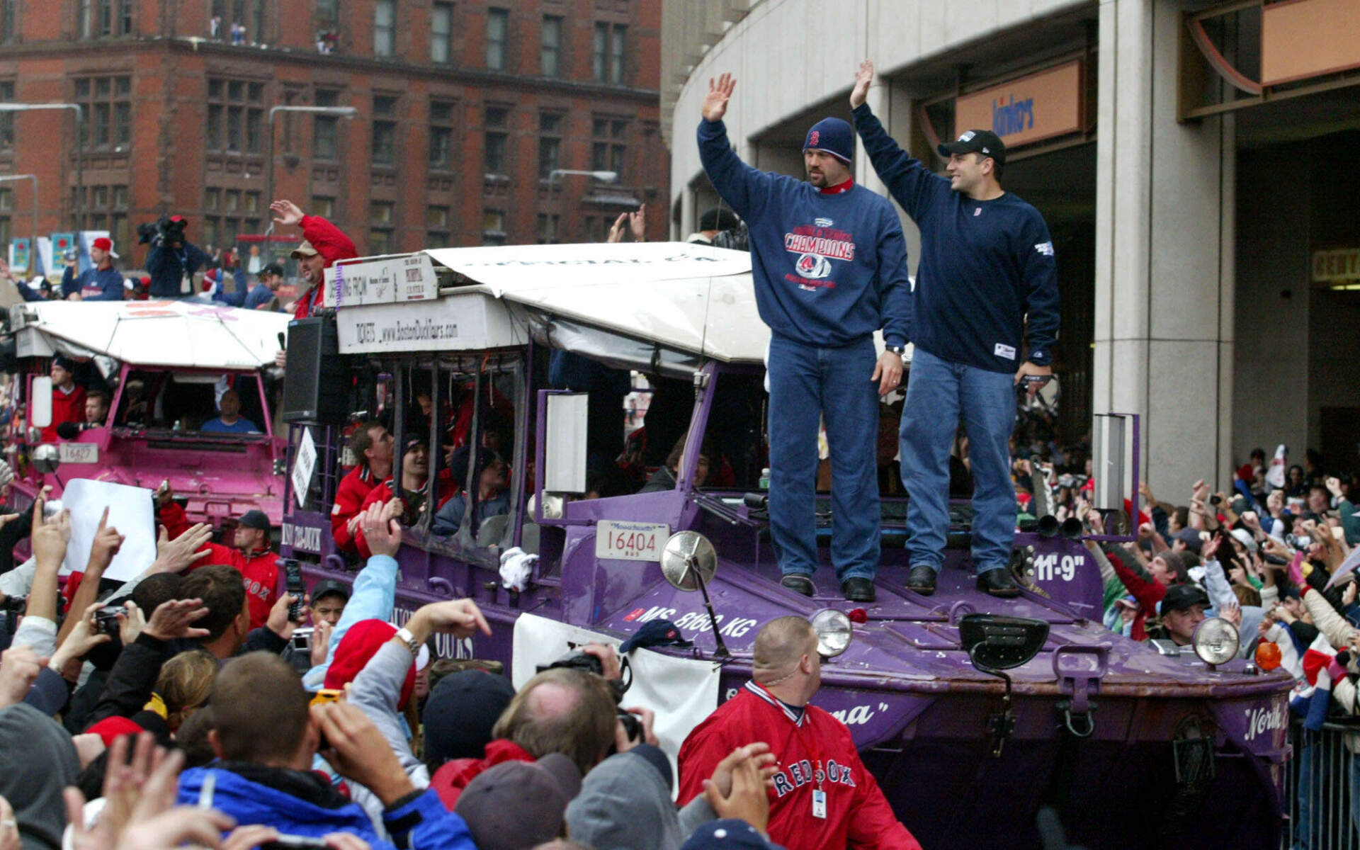 Boston Red Sox catchers Jason Varitek, left, and Doug Mirabelli, acknowledge the crowd during the Boston Red Sox's victory parade, Saturday, Oct, 30, 2004 in Boston. (Bizuayehu Tesfaye/AP)