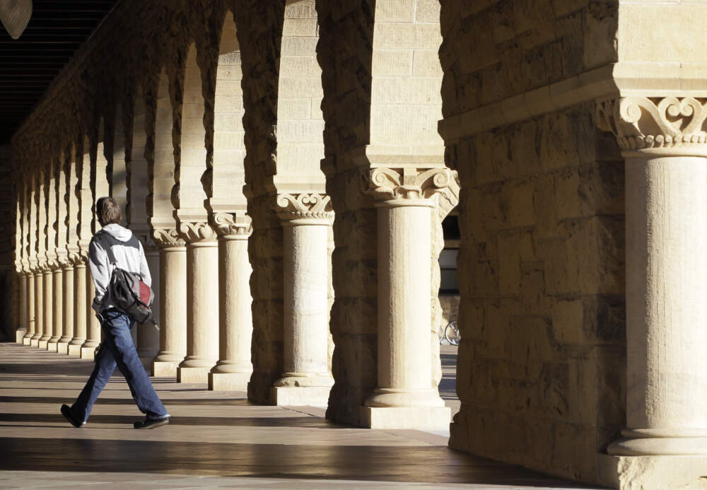 A Stanford University student walks though the halls of the Stanford University campus in Palo Alto, California. (Paul Sakuma/AP)