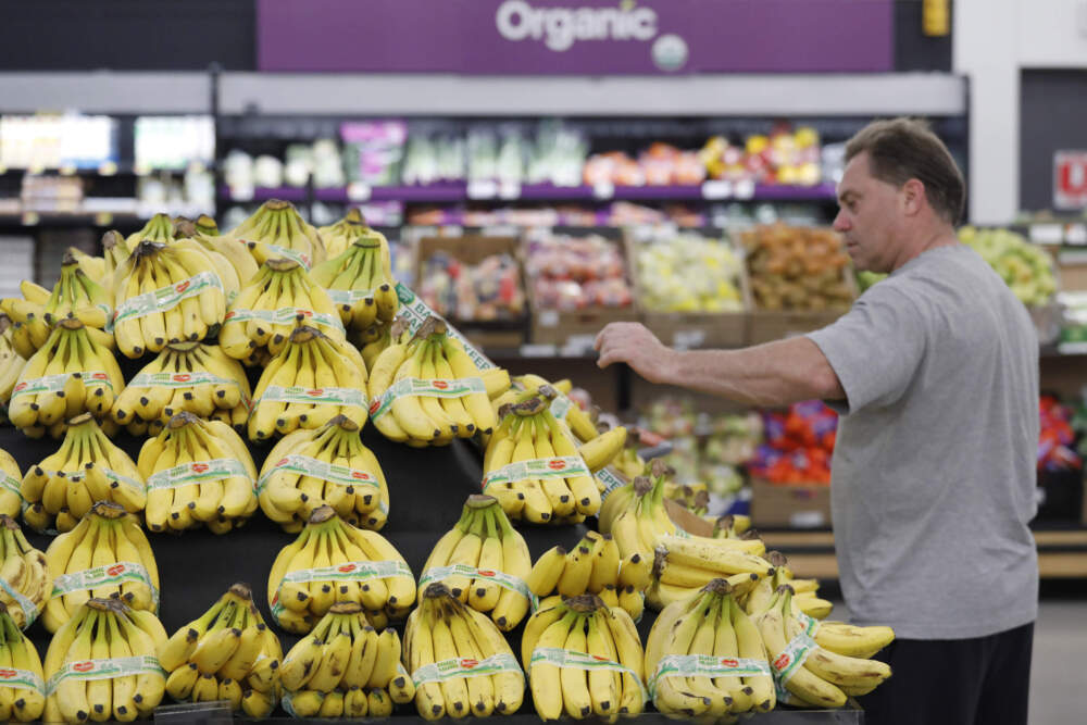 A customer shops for bananas at a Walmart Neighborhood Market in Levittown, N.Y. (Mark Lennihan/AP)