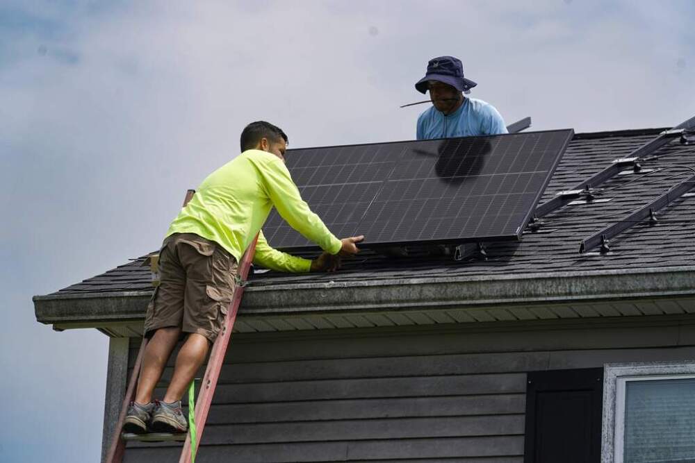 Workers install a solar panel on the roof of a home in Frankfort, Ky., on Monday, July 17, 2023. (Michael Conroy/AP)