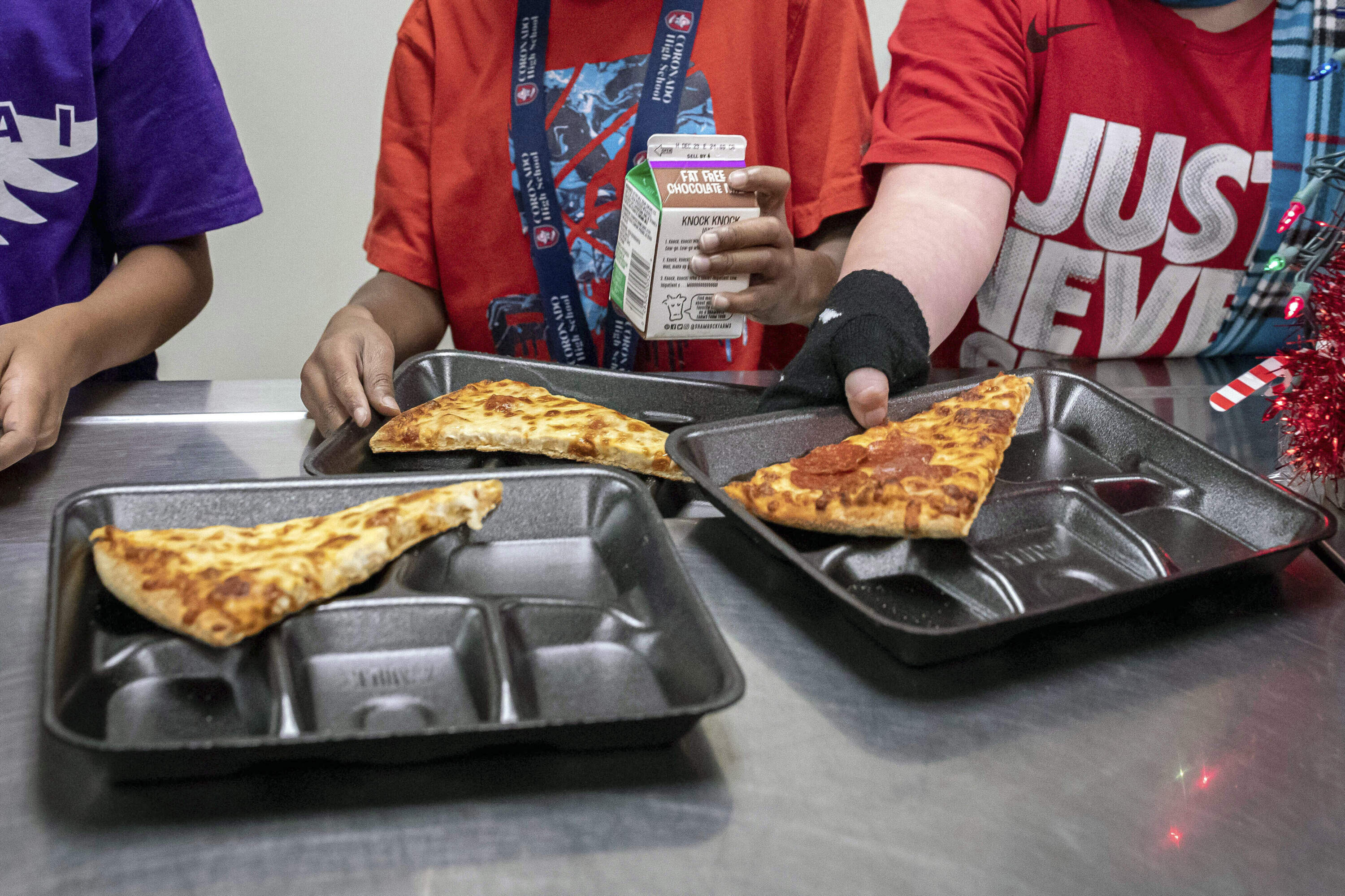Second-grade students select their meals during lunch break in the cafeteria. (Alberto Mariani/AP)