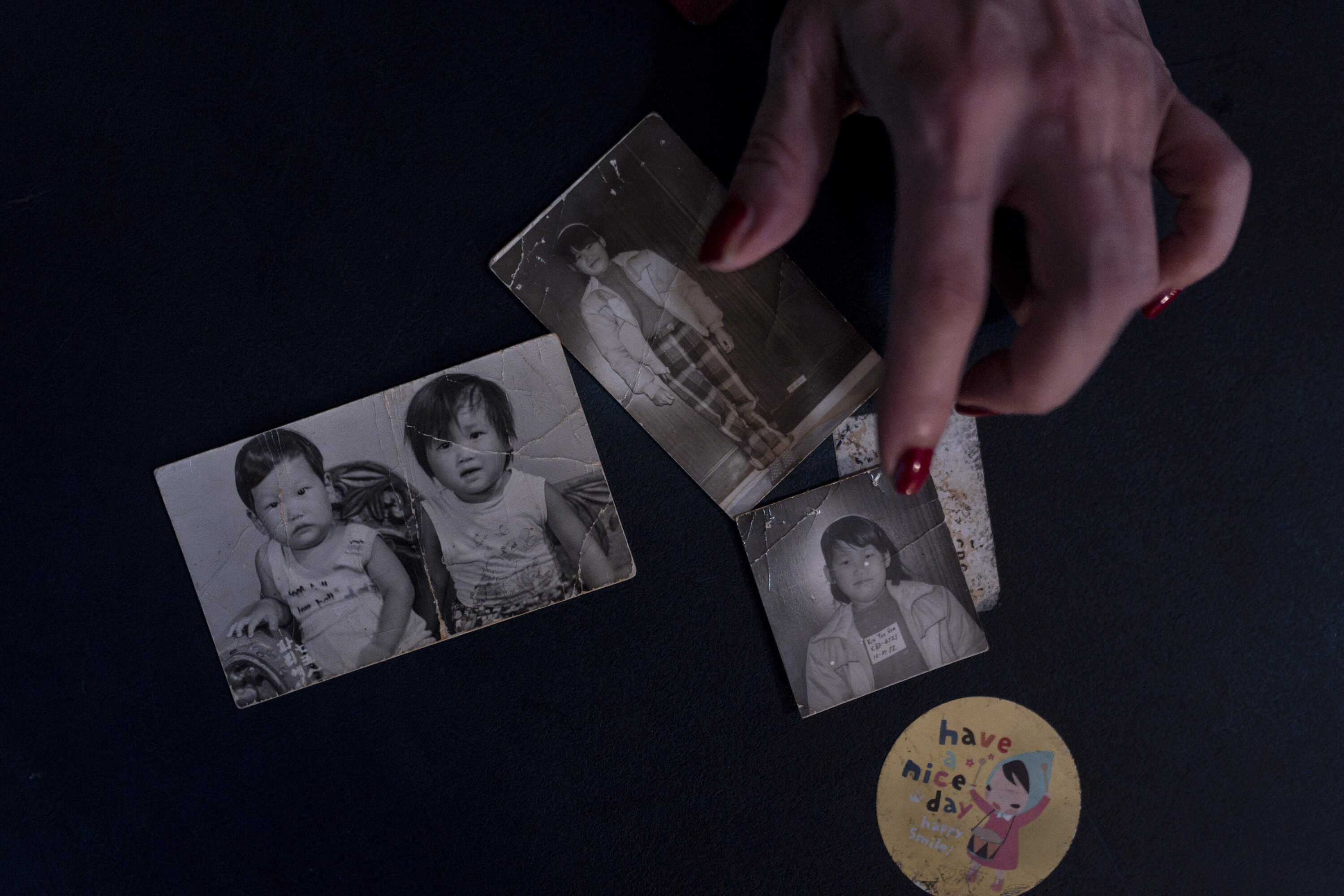 Yooree Kim, who was sent to a couple in France by the Holt adoption agency when she was 11, displays some old photos of her and her brother in her apartment in Seoul, Saturday, May 18, 2024. (Jae C. Hong/AP)