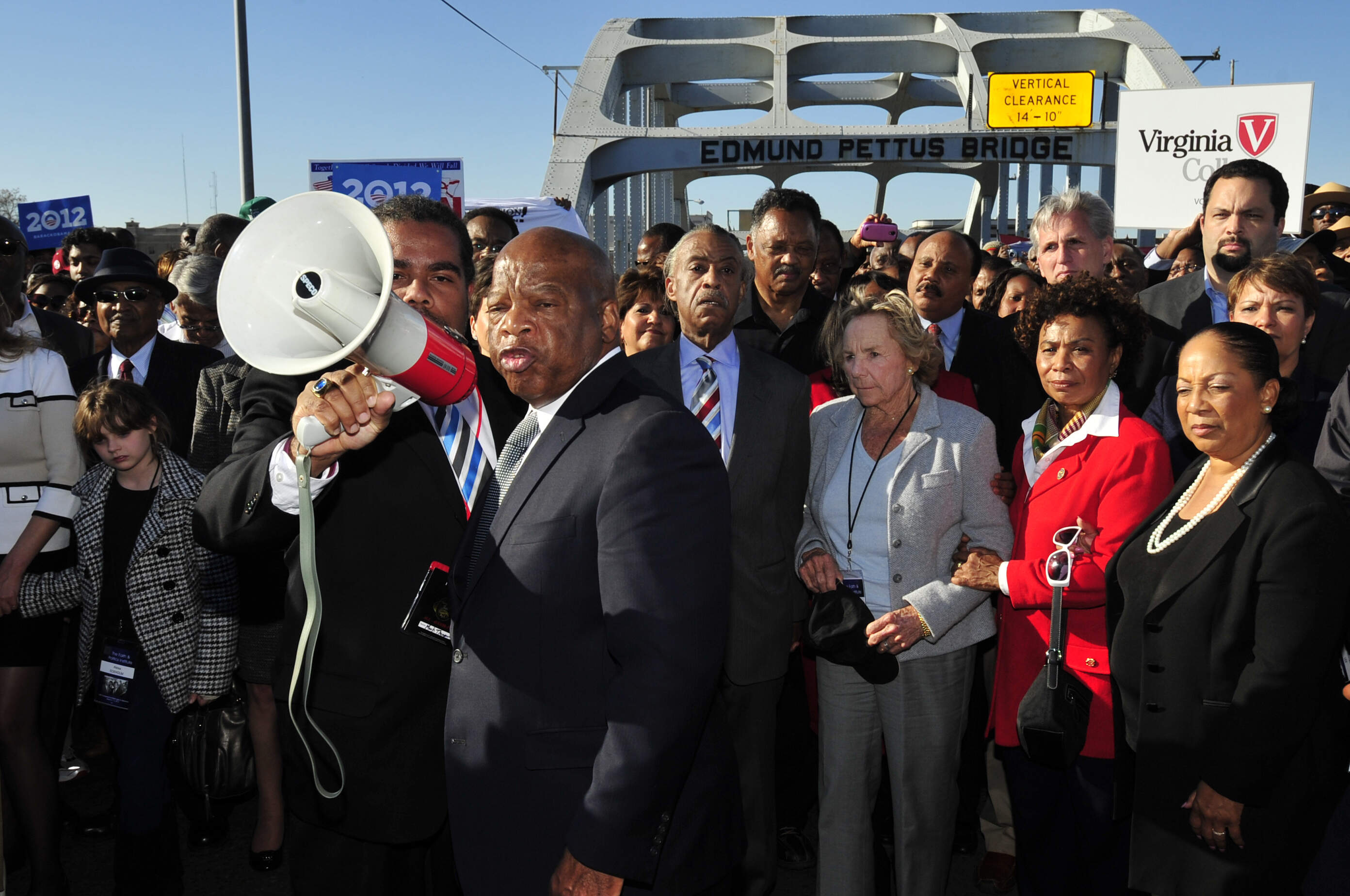 U.S. Rep. John Lewis talks with those gathered, including Ethel Kennedy and Rev. Jesse Jackson, on the historic Edmund Pettus Bridge in 2012, 47 years after the historic march that led to the Voting Rights Act. (Kevin Glackmeyer/AP)