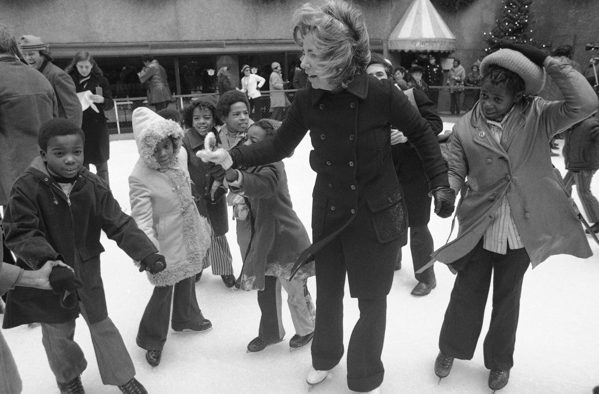 Ethel Kennedy ice skates with youngsters from Bedford Stuyvesant, Brooklyn borough, at the eighth annual Kennedy skating party originated by the late senator at Rockefeller Center's skating rink on Dec. 16, 1972, in New York. (AP photo)