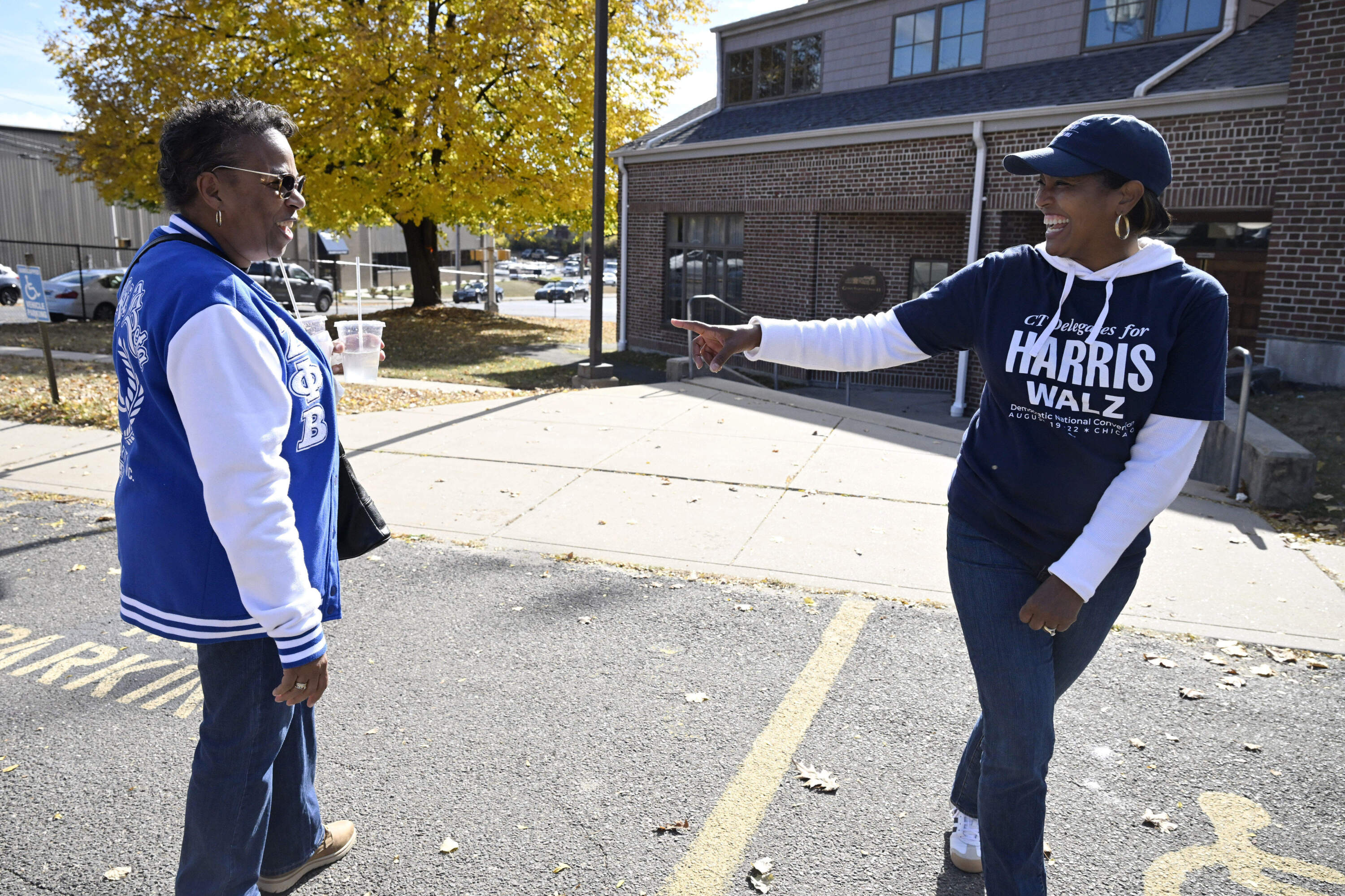 Linda Chapman of Waterbury, left, a member of the Zeta Phi Beta Sorority, Inc., talks with U.S. Rep. Jahana Hayes, D-Conn. at a Souls to the Polls voting rally at Grace Baptist Church Saturday, Oct. 26, 2024, in Waterbury, Connecticut. (Jessica Hill/AP)