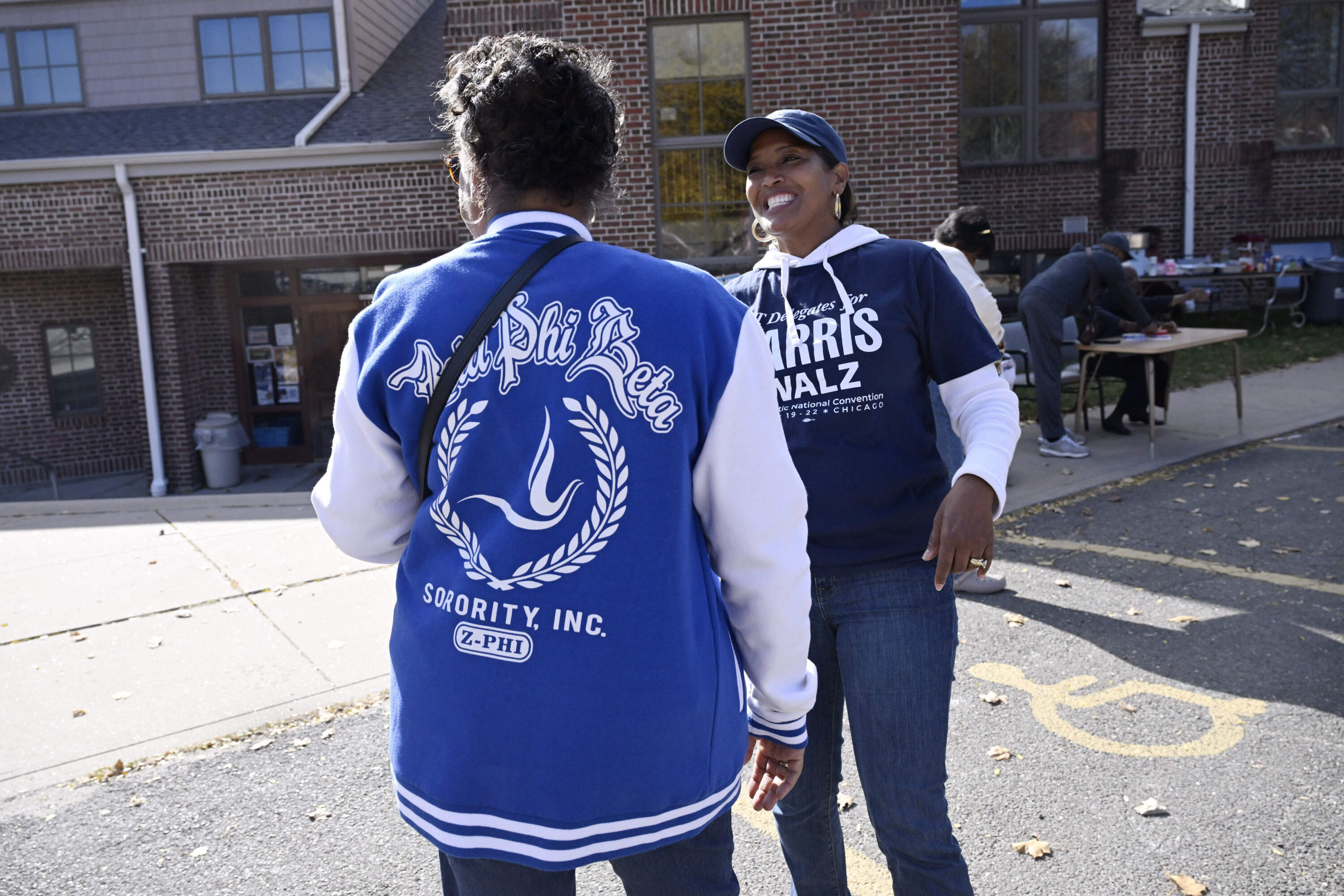 Linda Chapman of Waterbury, left, a member of the Zeta Phi Beta Sorority, Inc., talks with U.S. Rep. Jahana Hayes, D-Conn. at a Souls to the Polls voting rally at Grace Baptist Church, Oct. 26, 2024, in Waterbury. (Jessica Hill/AP)