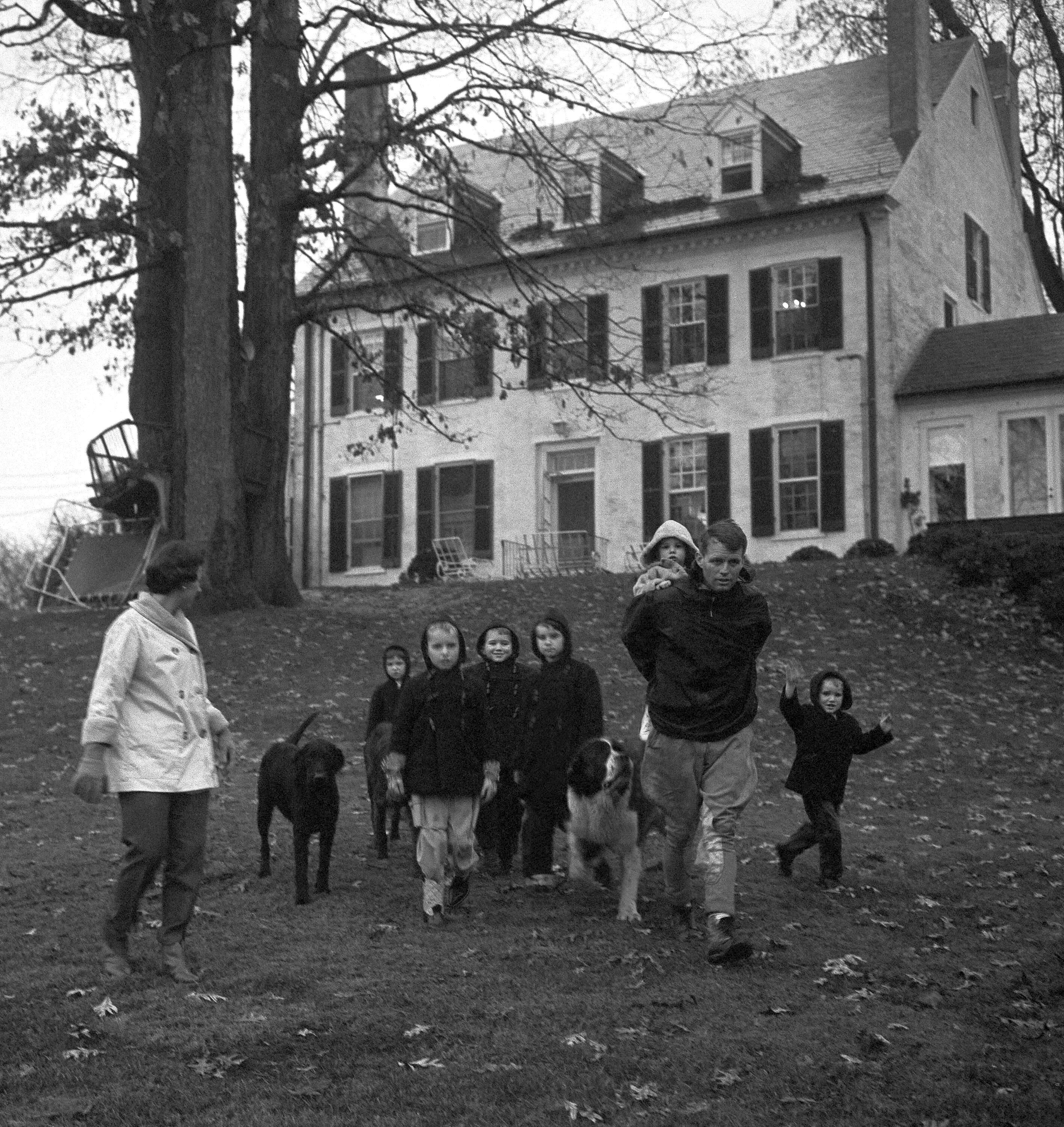 The Robert F. Kennedy family takes a walk at the Kennedy home in McLean, Va., on Dec. 30, 1959. From left: Mrs. Ethel Kennedy; Courtney, 3; Kathleen, 8; Joseph Patrick, 7; Robert Kennedy with one and a half-year-old Michael on his back; Bobby, 5; and David, 4. (Henry Griffin/AP)