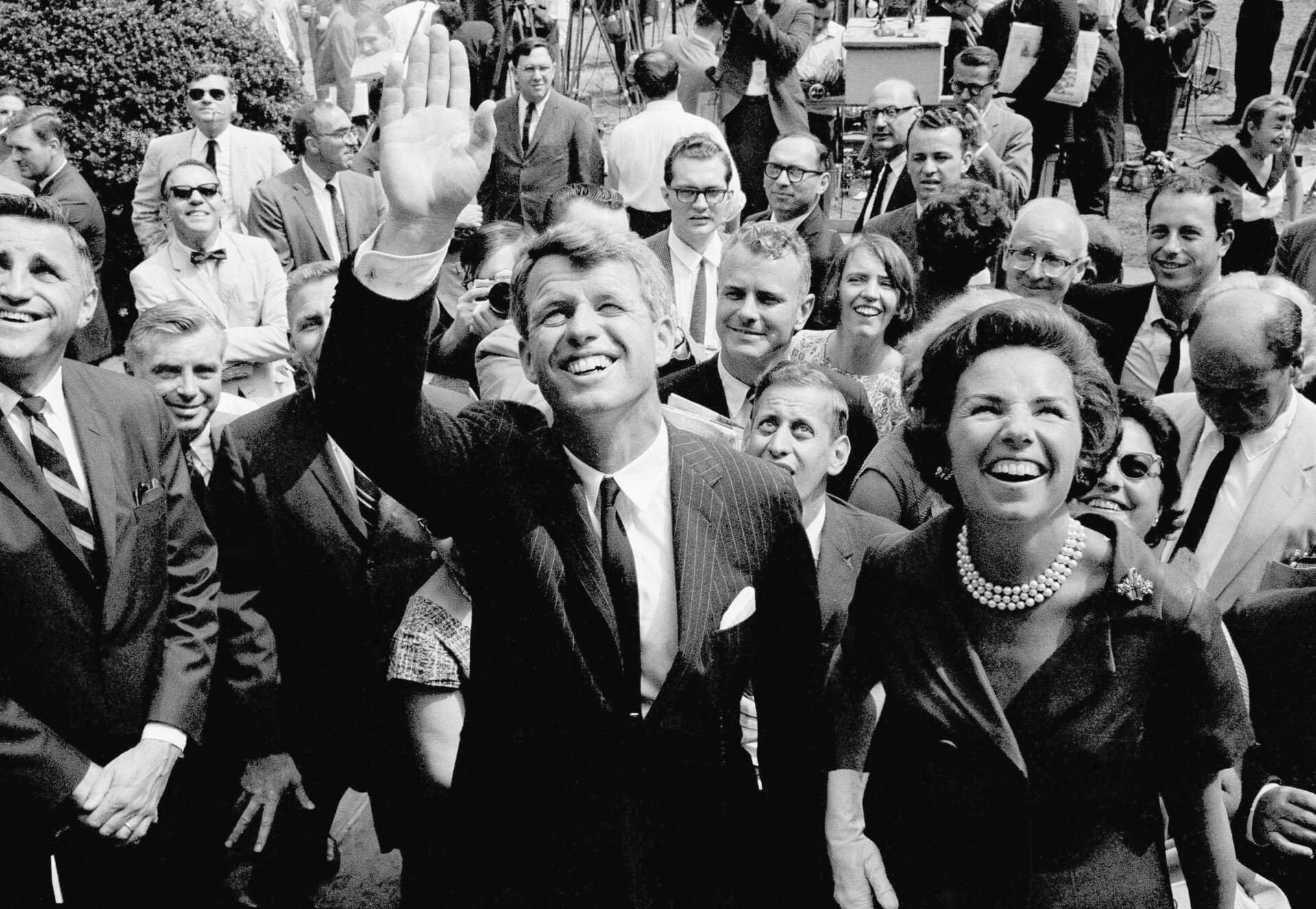 Atty. Gen. Robert F. Kennedy waves shortly after announcing that he would seek the Democratic nomination for the U.S. Senate from New York. On the right is his wife Ethel. Kennedy made the announcement on August 25, 1964 at the Gracie Mansion in New York, the official residence of New York City Mayor Robert Wagner. (AP photo)