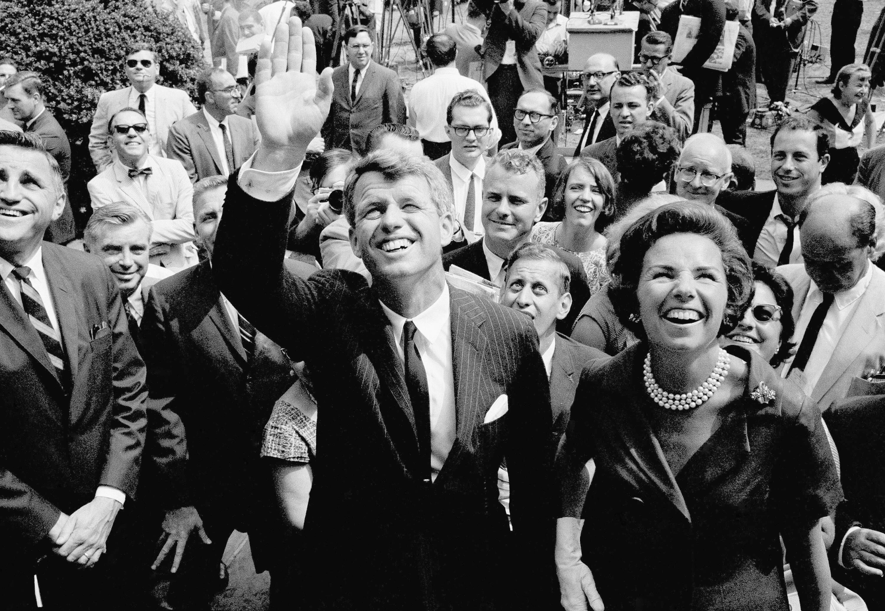 Atty. Gen. Robert F. Kennedy waves shortly after announcing he will seek the democratic nomination for the U.S. senate from New York. At right is his wife, Ethel. Kennedy made the announcement at Gracie Mansion, in New York, August 25, 1964 the official residence of New York Mayor Robert Wagner. (AP Photo)