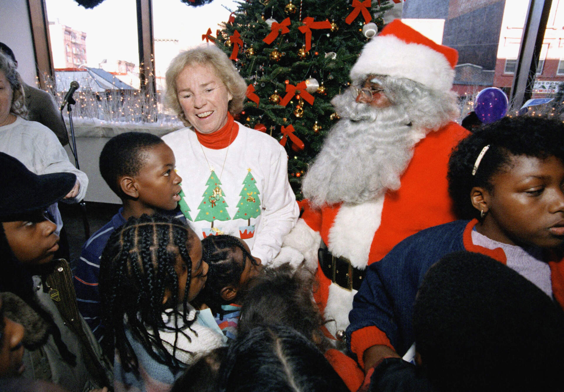 Ethel Kennedy and Santa Claus meet with children at the Bedford Stuyvesant Restoration Corporation skating rink in Brooklyn, New York City, Saturday, December 13, 1986, during the Robert F. Kennedy Memorial Skating Party for underprivileged children. (Rick Maiman/AP)