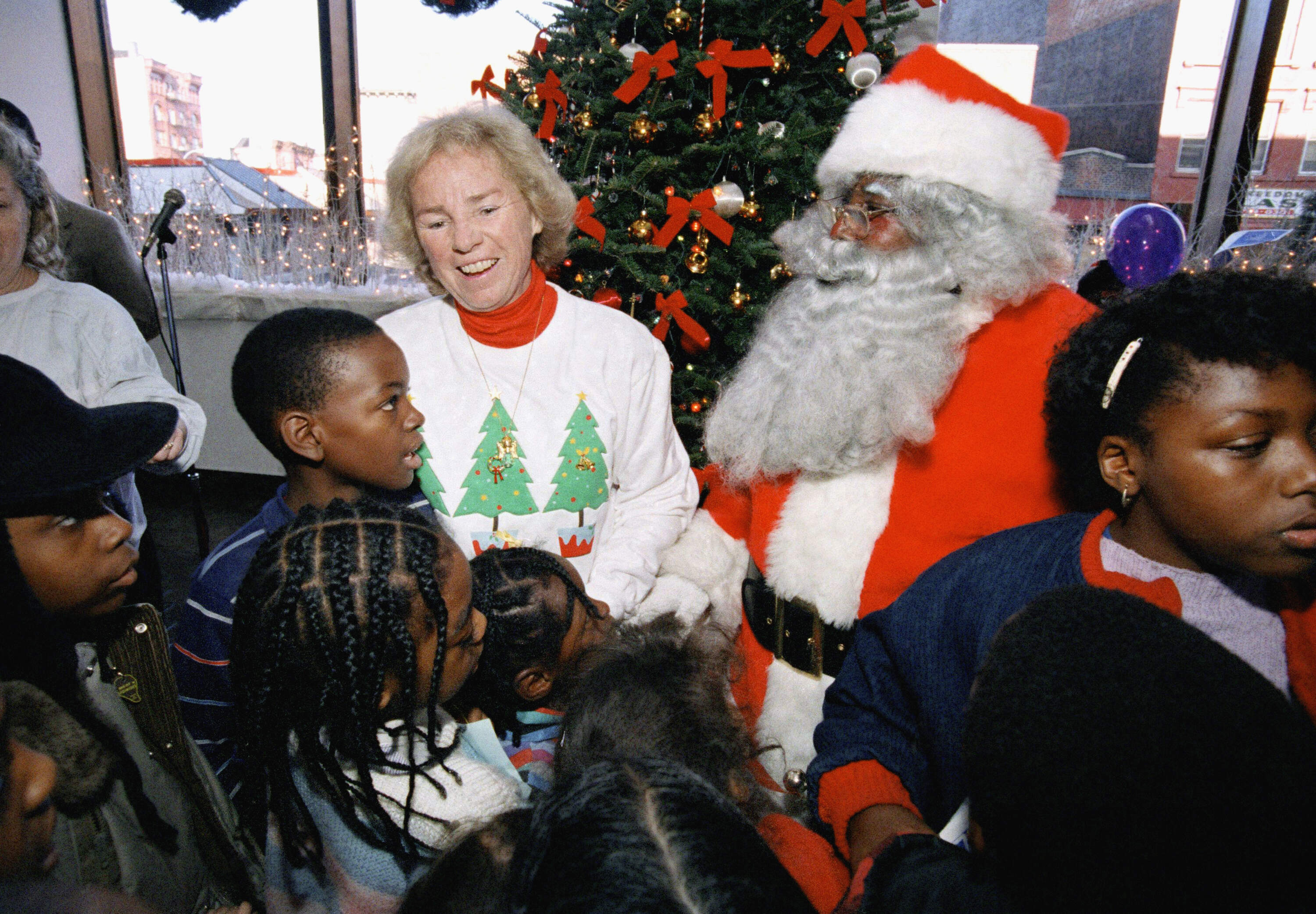 Ethel Kennedy and Santa Claus meet with children at the skating rink of the Bedford Stuyvesant Restoration Corporation in Brooklyn, New York City, Saturday, Dec. 13, 1986 during the Robert F. Kennedy Memorial Skating party for disadvantaged children. (Rick Maiman/AP)