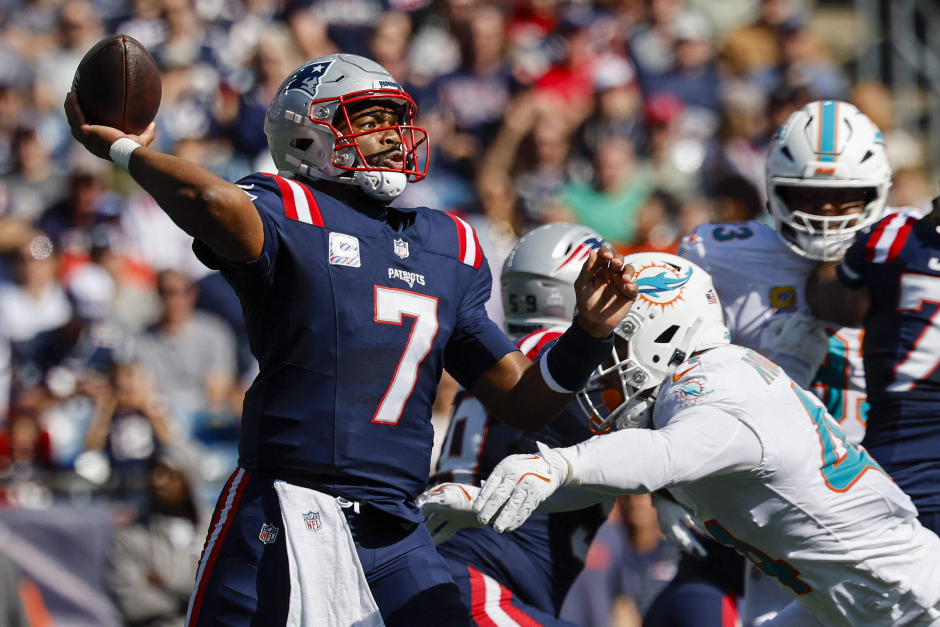 New England Patriots quarterback Jacoby Brissett (7) makes a pass while pressured by a Miami Dolphins linebacker during an NFL football game on Sunday, Oct. 6, 2024, in Foxborough, Mass. (Greg M. Cooper/AP)