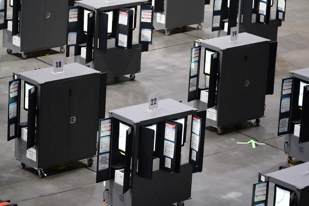 Voting machines fill the floor for early voting at State Farm Arena, Oct. 12, 2020, in Atlanta. (AP Photo/Brynn Anderson, File)