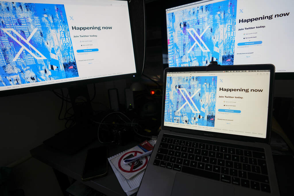 Computer monitors and a laptop display the X, formerly known as Twitter, sign-in page, July 24, 2023, in Belgrade, Serbia. The secretaries of state from Michigan, Minnesota, New Mexico, Pennsylvania and Washington are urging Elon Musk to fix an AI chatbot on his social media platform X, saying in a letter Monday, August. 5, 2024, that it has spread election misinformation. (AP Photo/Darko Vojinovic, File)