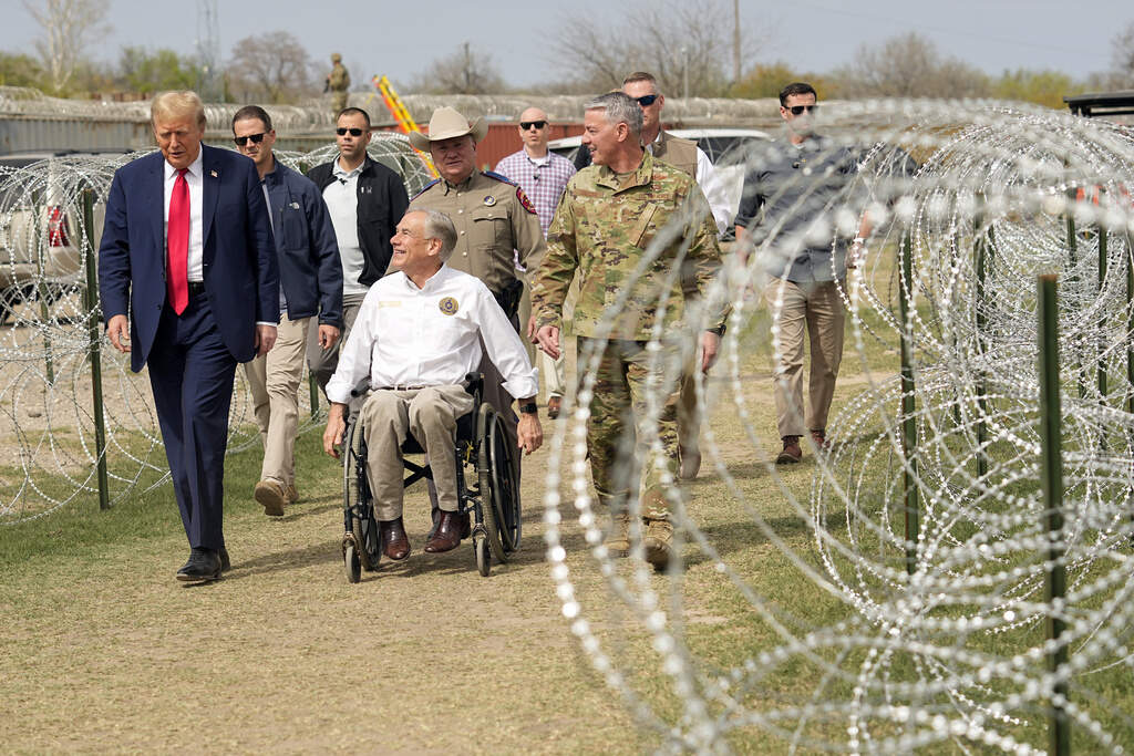 Republican presidential candidate former President Donald Trump talks with Texas Gov. Greg Abbott during a visit to the U.S.-Mexico border, Feb. 29, 2024, in Eagle Pass, Texas. (AP Photo/Eric Gay, File)