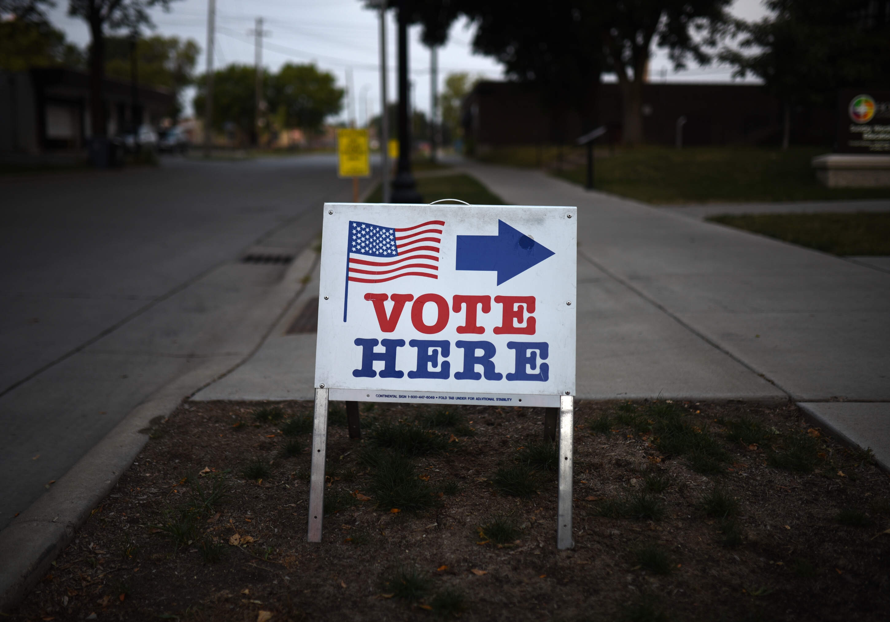 A sign reading "Vote Here" points toward a polling place for the 2018 Minnesota primary election at Holy Trinity Lutheran Church on Aug. 14, 2018 in Minneapolis, Minnesota. (Stephen Maturen/Getty Images)