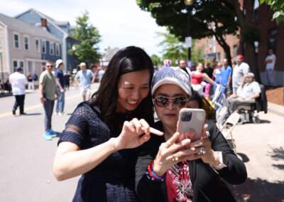 Boston Mayor Michelle Wu takes a selfie with a woman at the Bunker Hill Day Parade in June 2024. (Jessica Rinaldi/The Boston Globe via Getty Images)