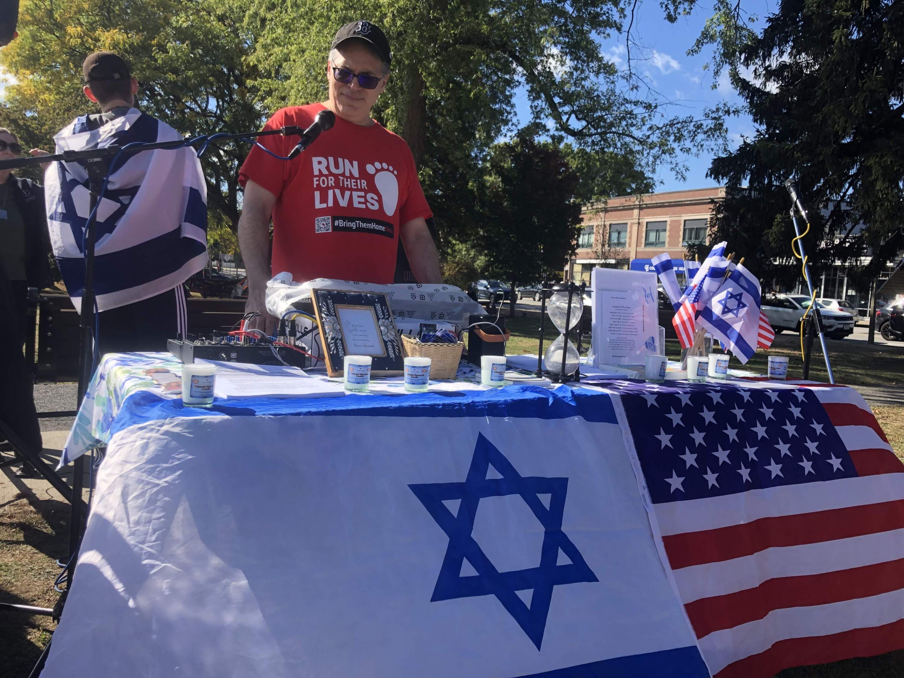 Behzad Dayanim of Newton plays music during a gathering in Newton to show support for Jewish hostages captured by Hamas in the Oct. 7 attack. (Wilder Fleming/WBUR)