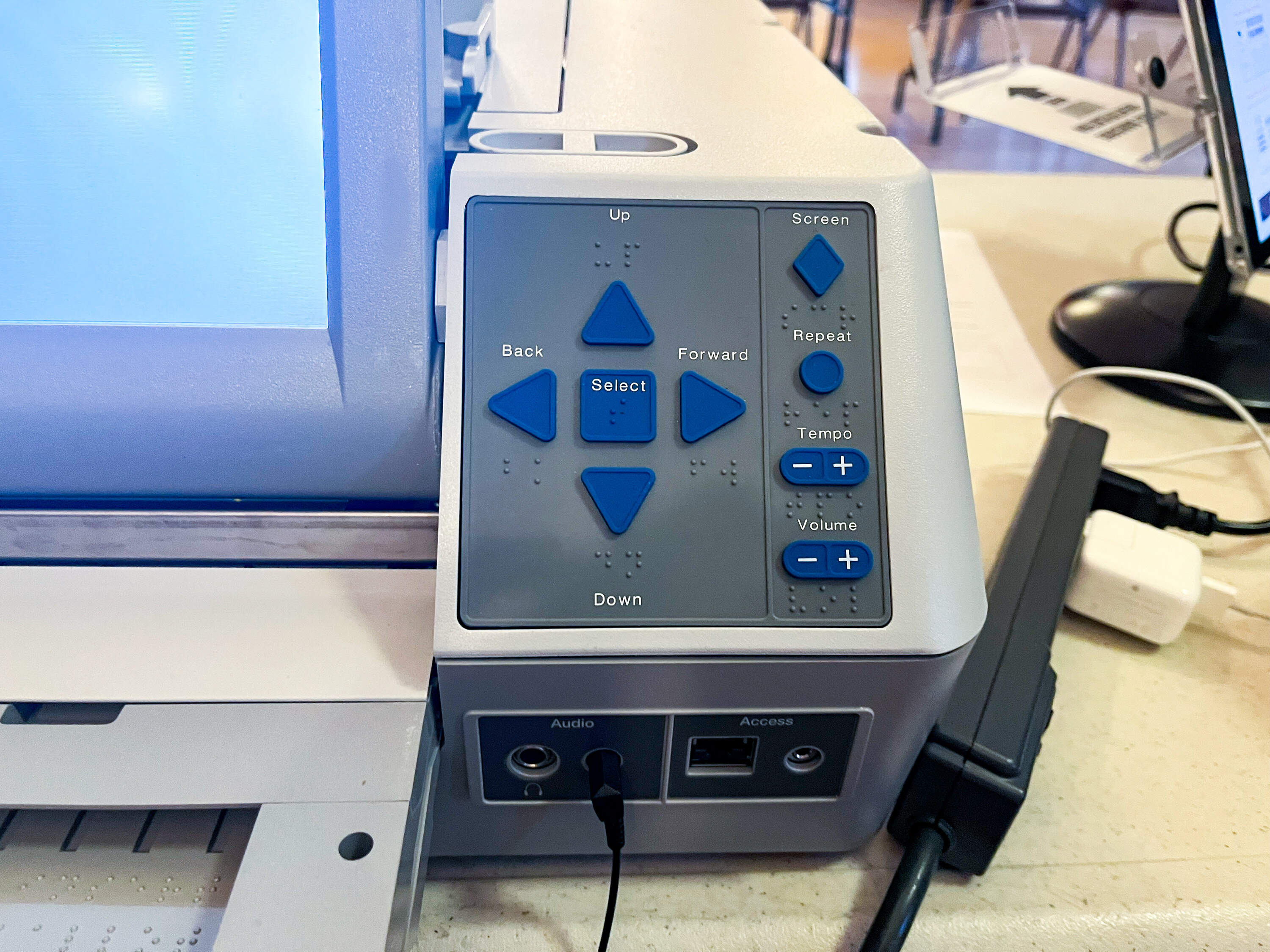 Part of an AutoMARK machine, featuring arrow keys and buttons marked with braille to allow voters who are blind or low vision to cast their ballots independently. (Emily Piper-Vallillo/WBUR)