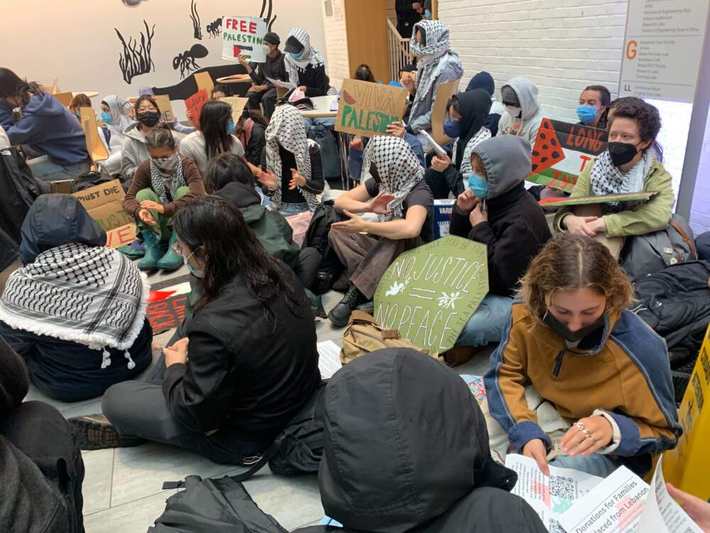 Pro-Palestinian protesters demonstrating inside the Tufts University Science and Engineering Complex building. (Carrie Jung/WBUR)