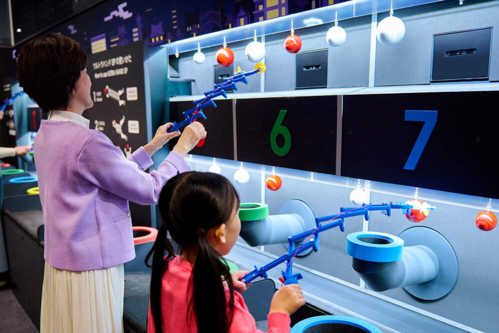 Visitors play with an interactive exhibit at the Nintendo Museum. (Courtesy of Nintendo)