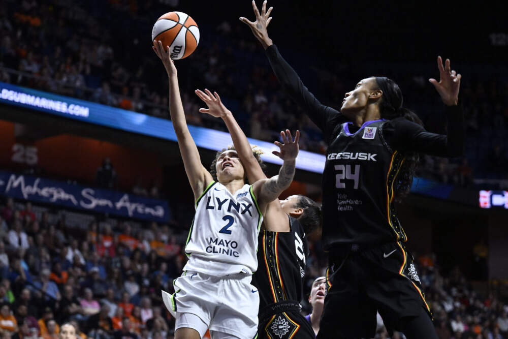 Connecticut Sun guard Veronica Burton, center, fouls Minnesota Lynx guard Natisha Hiedeman, left, as Connecticut Sun forward DeWanna Bonner, right, defends, during the first half of Game 4 in the WNBA basketball semifinals. (Jessica Hill/AP)