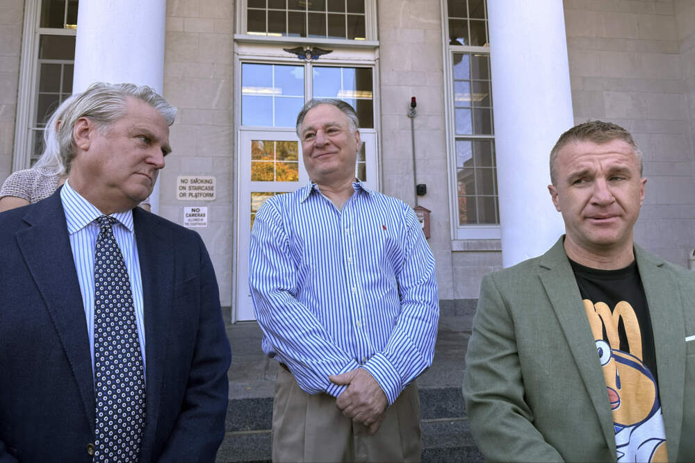 Richard Schiffer Jr., center, who faces witness intimidation and other charges related to the Karen Read case, greets supporters alongside Aidan Kearney (right). (Michael Casey/AP)