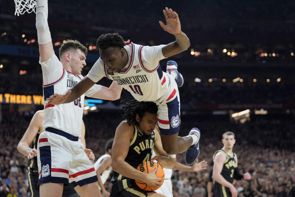 UConn guard Hassan Diarra (10) goes over the top of Purdue forward Trey Kaufman-Renn (4) during the first half of the NCAA college Final Four championship basketball game, Monday, April 8, 2024, in Glendale, Ariz. (David J. Phillip/AP)
