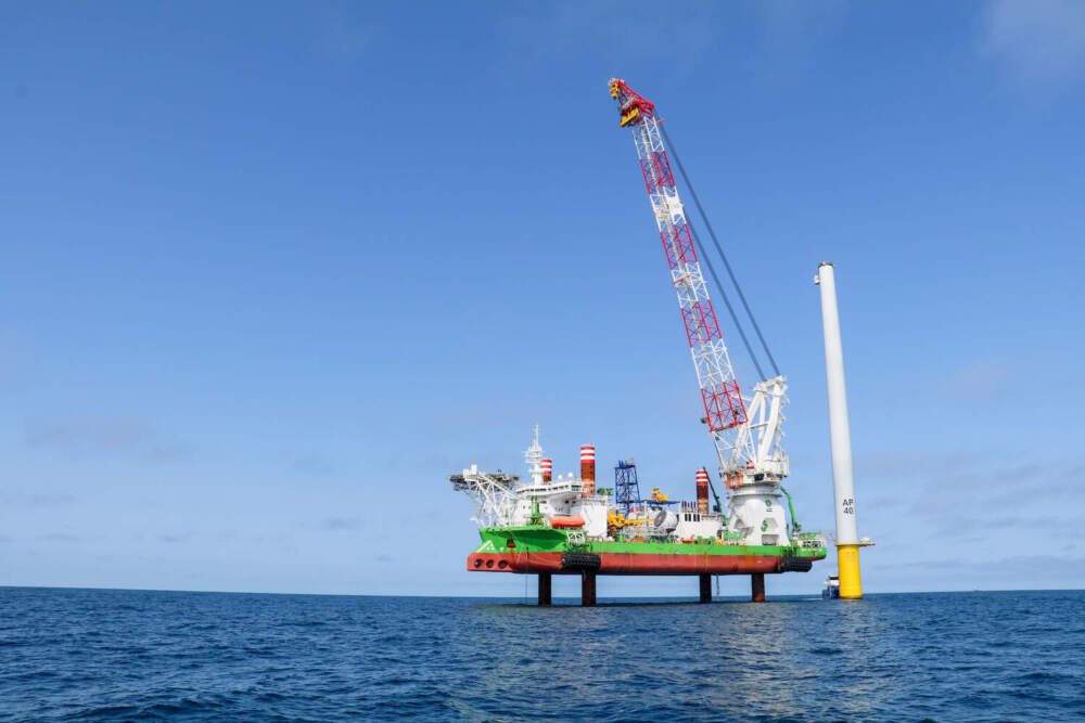 The Sea Installer, a 434-foot long &quot;jack-up vessel&quot; stands next to a partially constructed turbine in the Vineyard Wind project. (Liz Lerner/CAI)